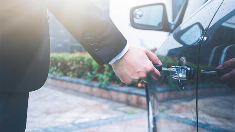 Driver opening a car door with a key